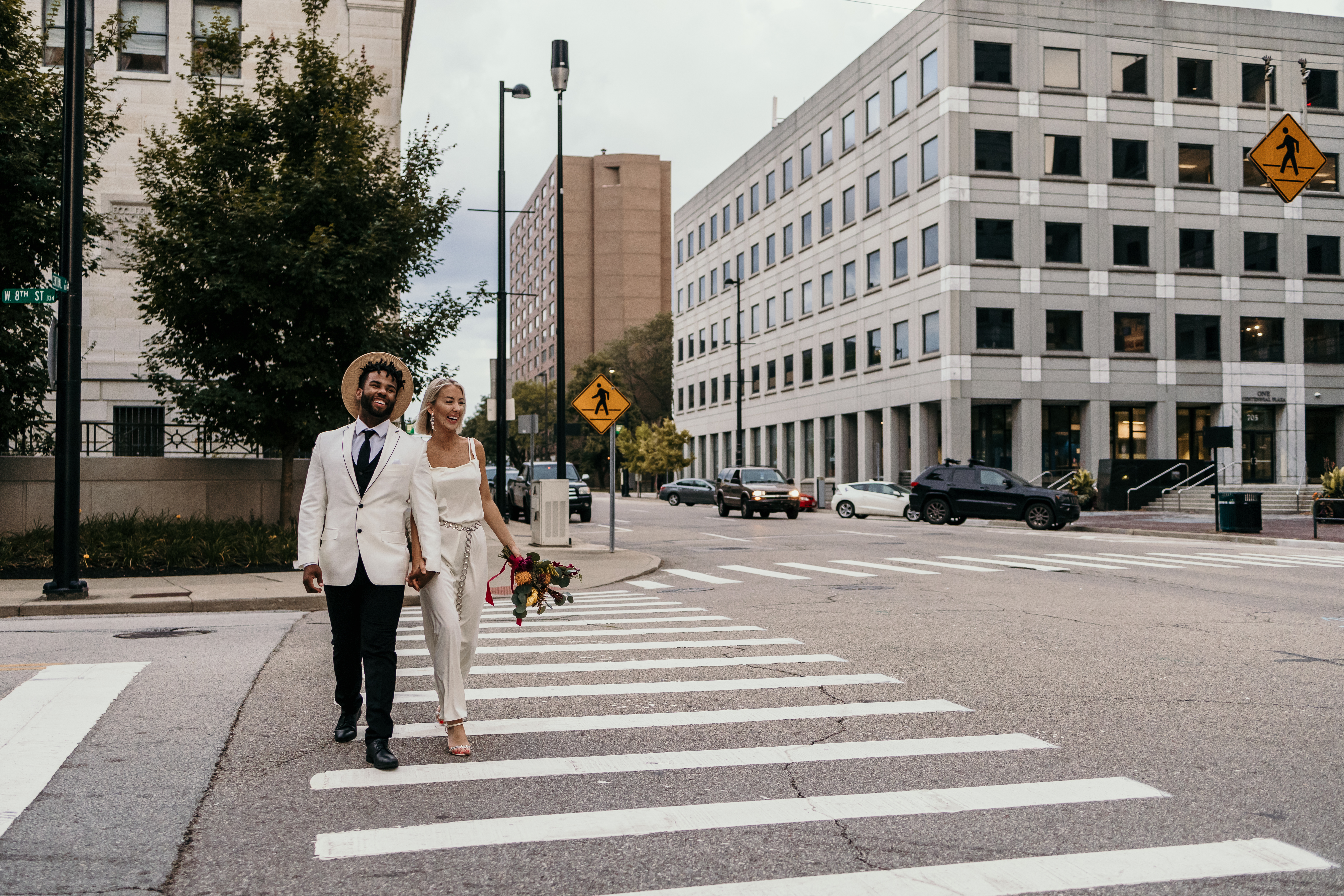 a couple walking across the street after eloping at city hall in downtown Cincinnati ohio