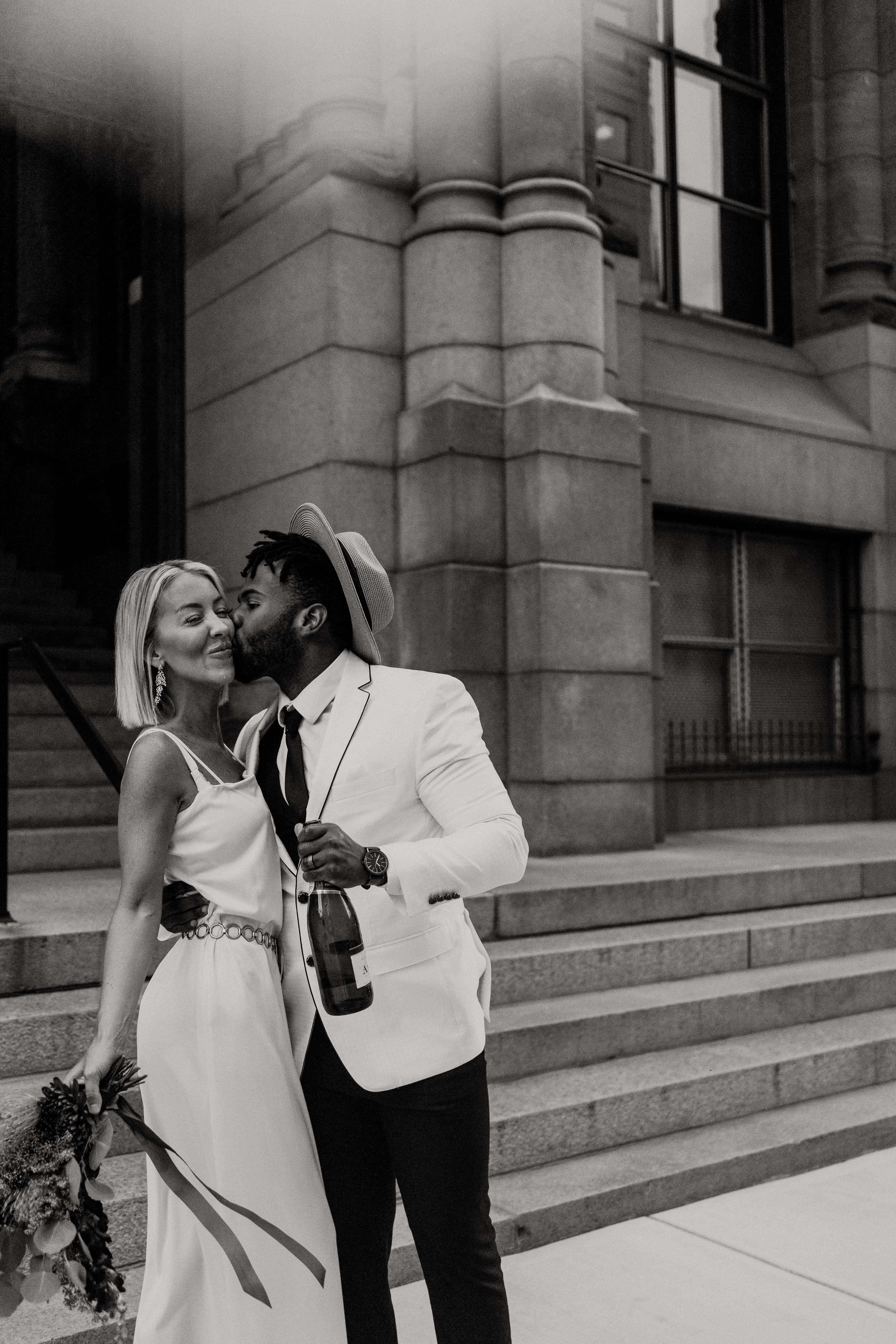 black and white image of couple in front of city hall