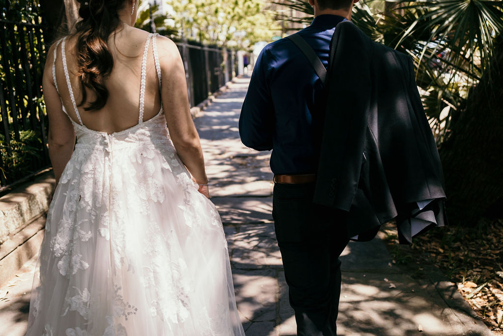 couple enjoying a walk around downtown charleston, sc. after their small wedding ceremony